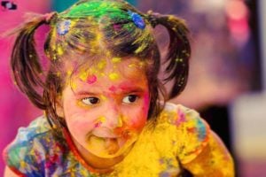 a paint covered girl during holi festival in india